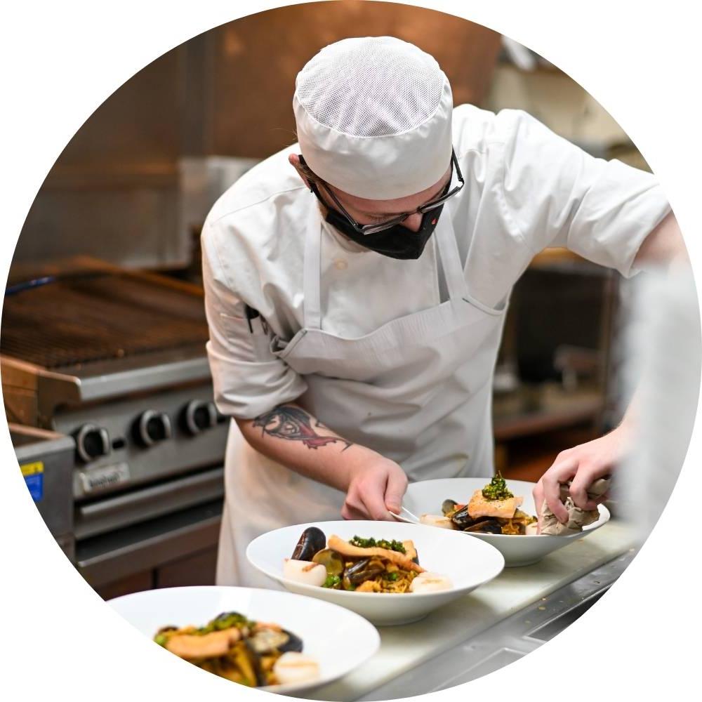 photo of culinary student plating finished meals